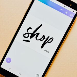 Close-up of a smartphone screen with a 'Shop' application interface on a light background.